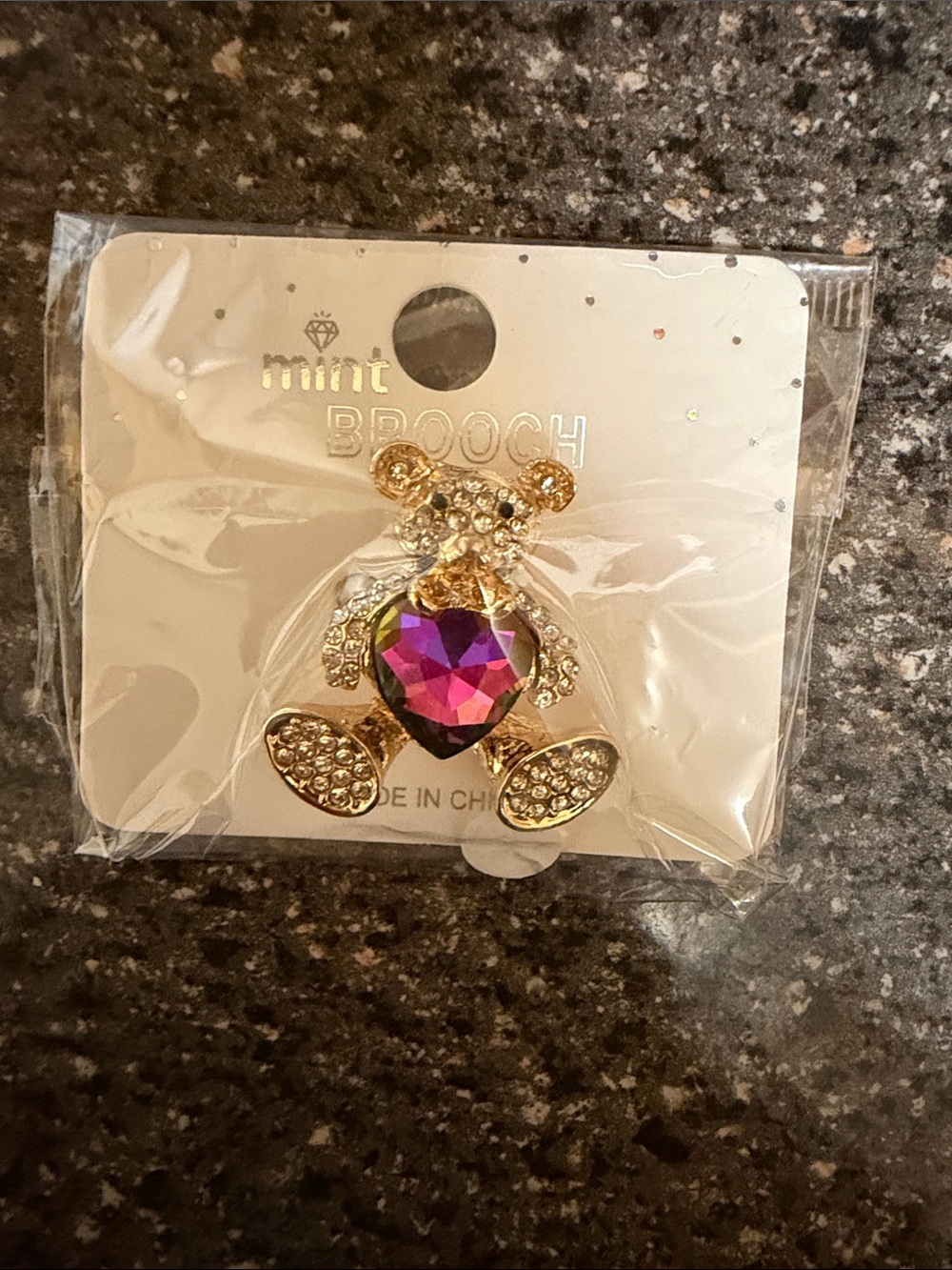 mint gold-tone teddy bear brooch with iridescent purple heart crystal